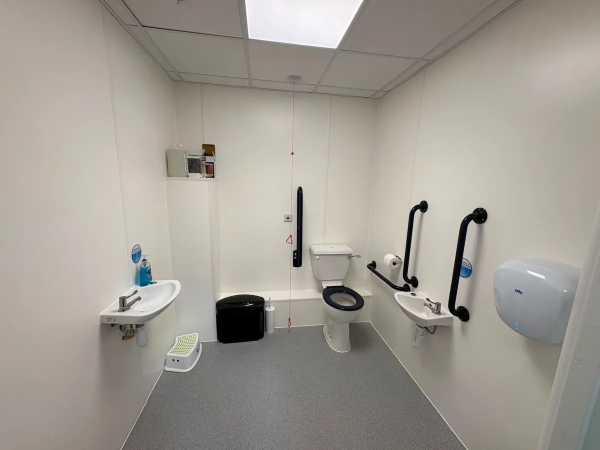 Tiled family bathroom with bath, screen and concealed cistern joinery
