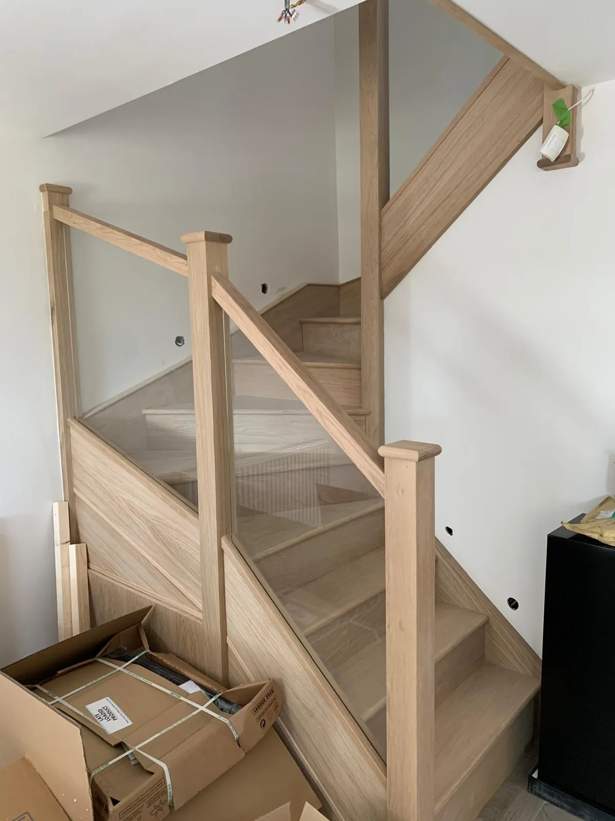 Bespoke oak and glass staircase with feature balustrade by Kraft Interiors